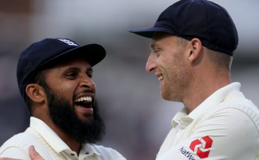 England's Adil Rashid and Jos Buttler (right) after the end of play during the test match at The Kia Oval, London.