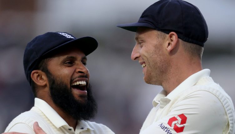 England's Adil Rashid and Jos Buttler (right) after the end of play during the test match at The Kia Oval, London.