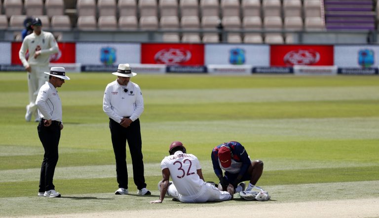 West Indies' John Campbell receives medical treatment prior to retiring injured