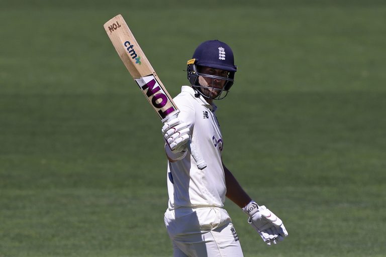 Dawid Malan raises his bat after making 50