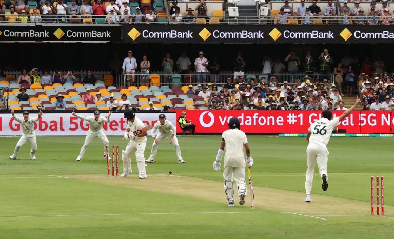 Mitchell Starc takes the wicket of Rory Burns with the first ball of the 2021-22 Ashes (Jason O'Brien/PA)