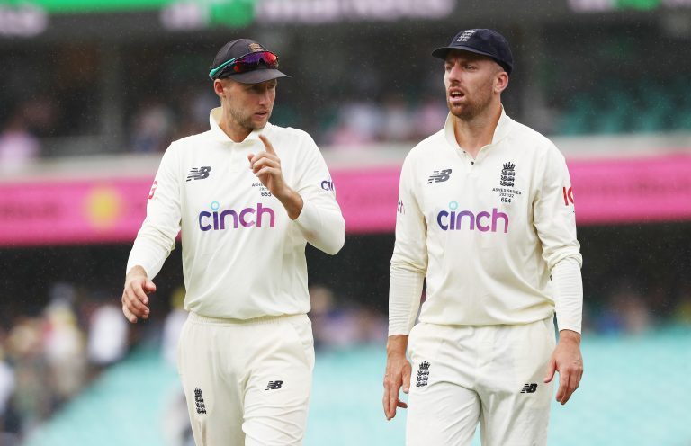 England's Joe Root (left ) and Jack Leach walk off as rain stops play