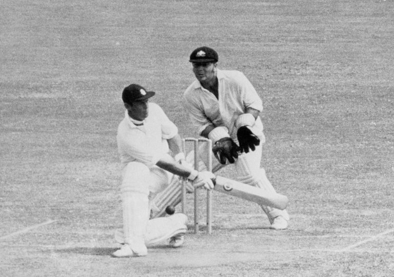 England's Geoff Boycott (l) tries to sweep as Rod Marsh (r) looks on