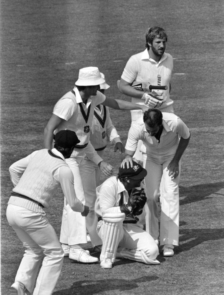 Ian Botham heads off after being caught by Rod Marsh while Dennis Lillee (hatless), the bowler, congratulates Marsh