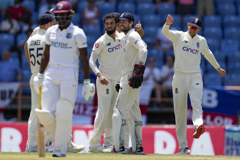 Shamarh Brooks, left, leaves the field after being dismissed by Saqib Mahmood, centre