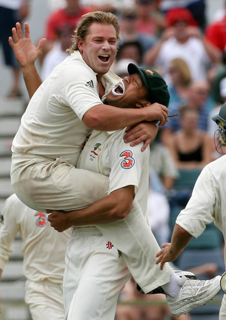 Australia's Shane Warne (left) celebrates with Andrew Symonds after taking the final wicket of England's Monty Panesar