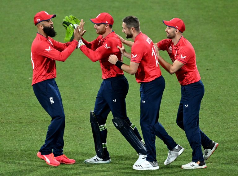 Chris Woakes, second right, took two for 33 in England's win over New Zealand (PA)