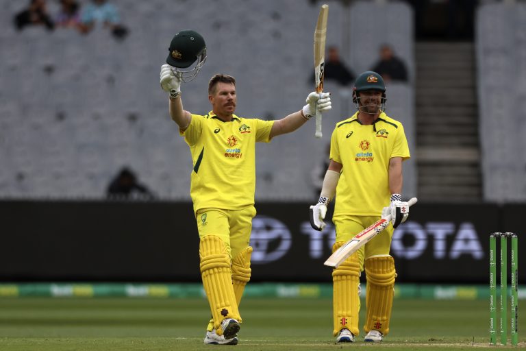 David Warner, left, is watched by Australia teammate Travis Head as he celebrates making his century
