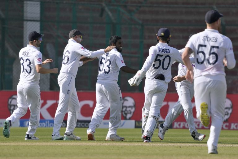 Rehan Ahmed, centre, is congratulated by team-mates after taking the wicket of Pakistan's Saud Shakeel
