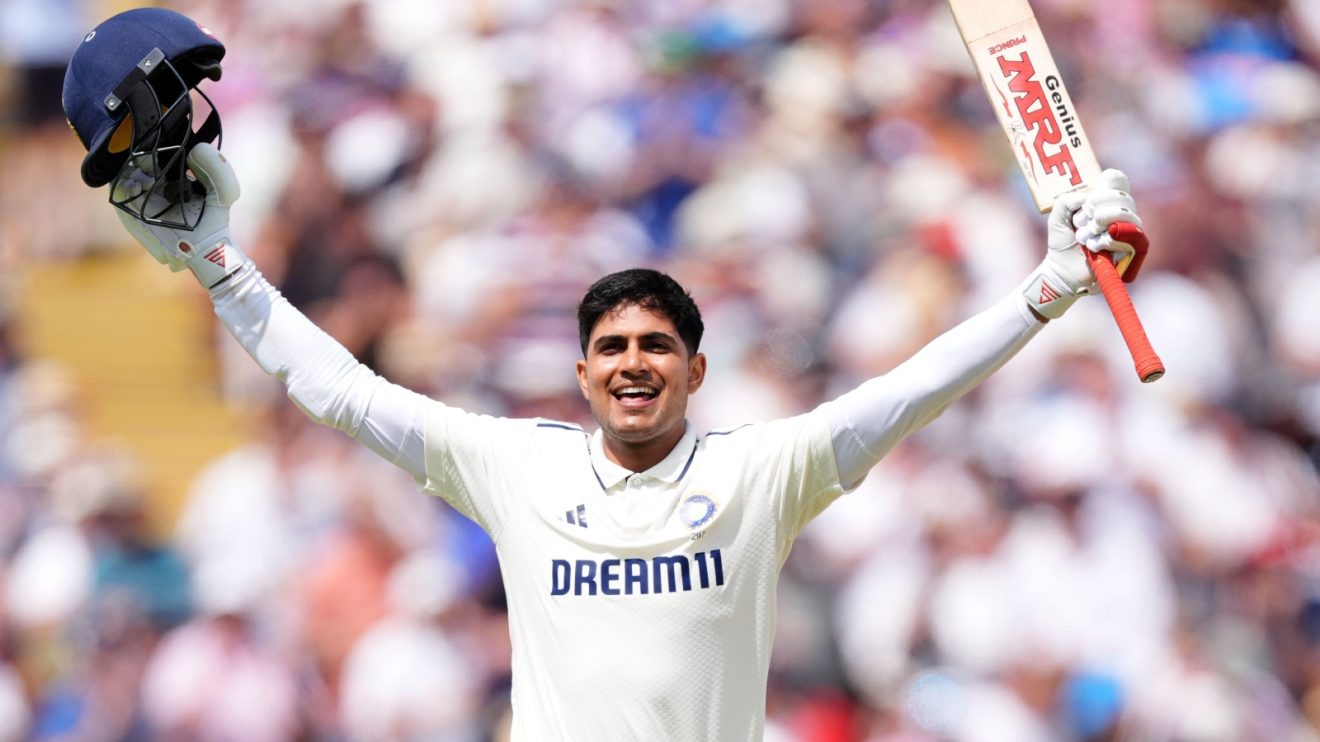 Shubman Gill raises his India helmet and cricket bat aloft after scoring a double century against England at Edgbaston