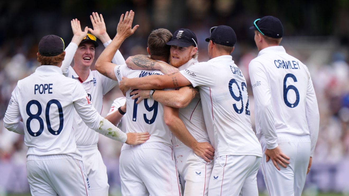 England's Chris Woakes (second left) is embraced by captain Ben Stokes after taking the wicket of India's Nitish Kumar Reddy