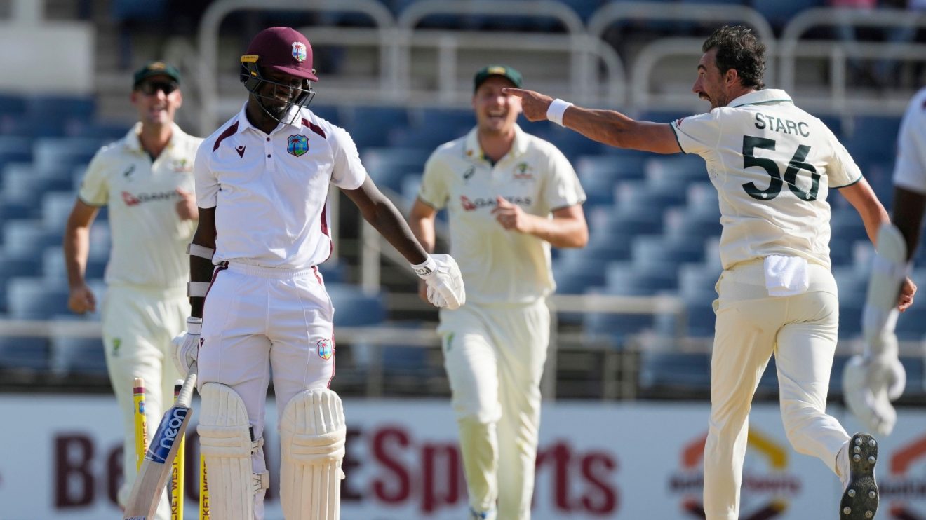Australia's Mitchell Starc celebrates taking the wicket of West Indies' Jayden Seales, left, on day three of the third Test cricket match