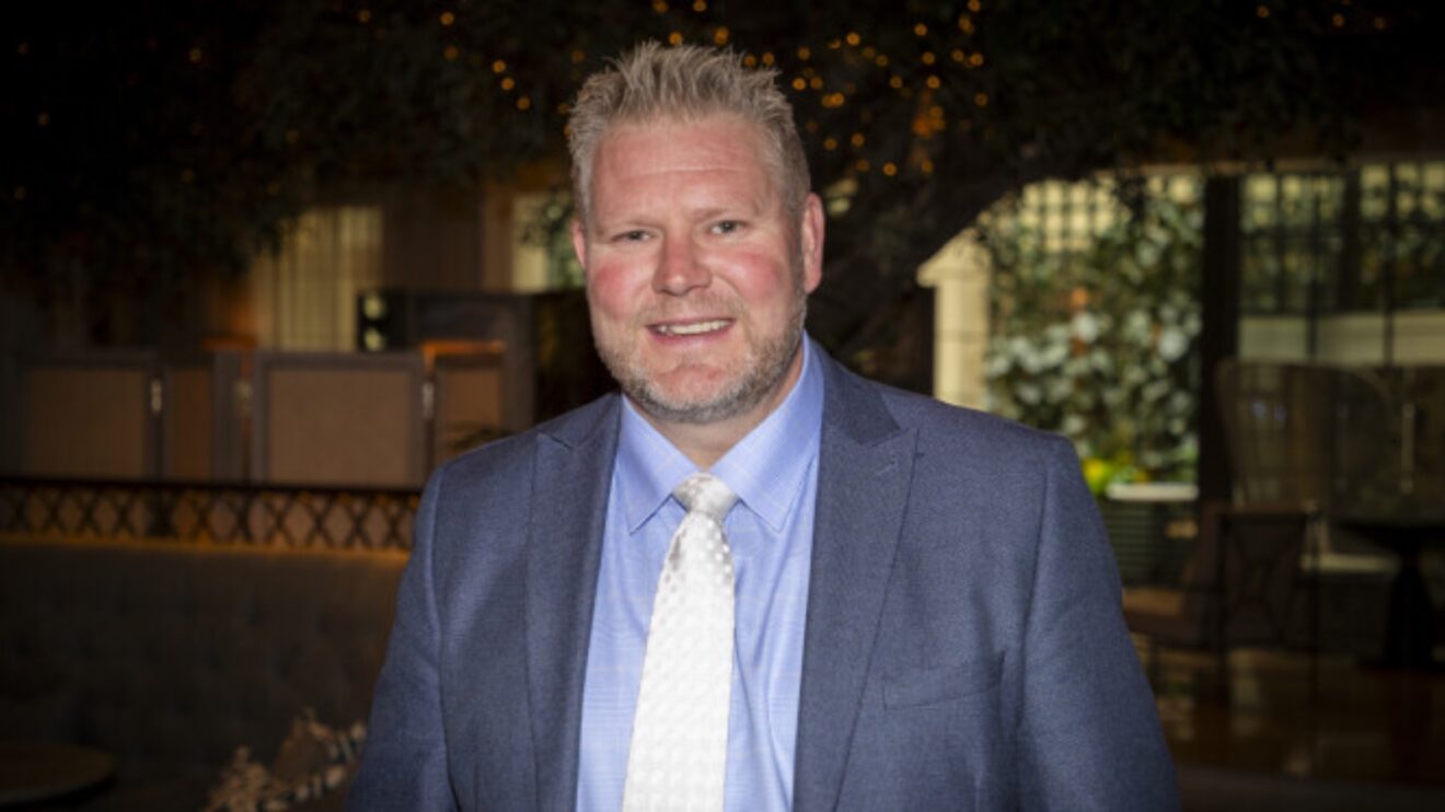 Former Yorkshire and England bowler Matthew Hoggard, in a suit, smiles to the camera